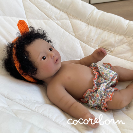 Moly, a girl with black afro hair, brown eyes, and dark skin.