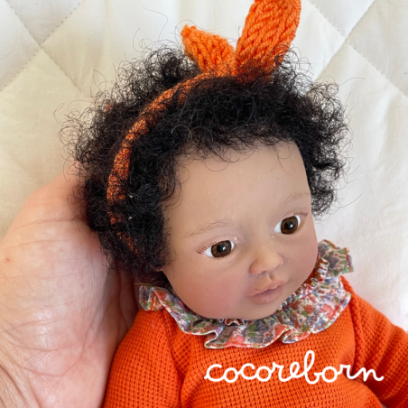 Moly, a girl with black afro hair, brown eyes, and dark skin.