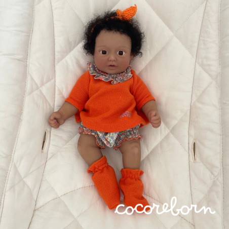 Moly, a girl with black afro hair, brown eyes, and dark skin.