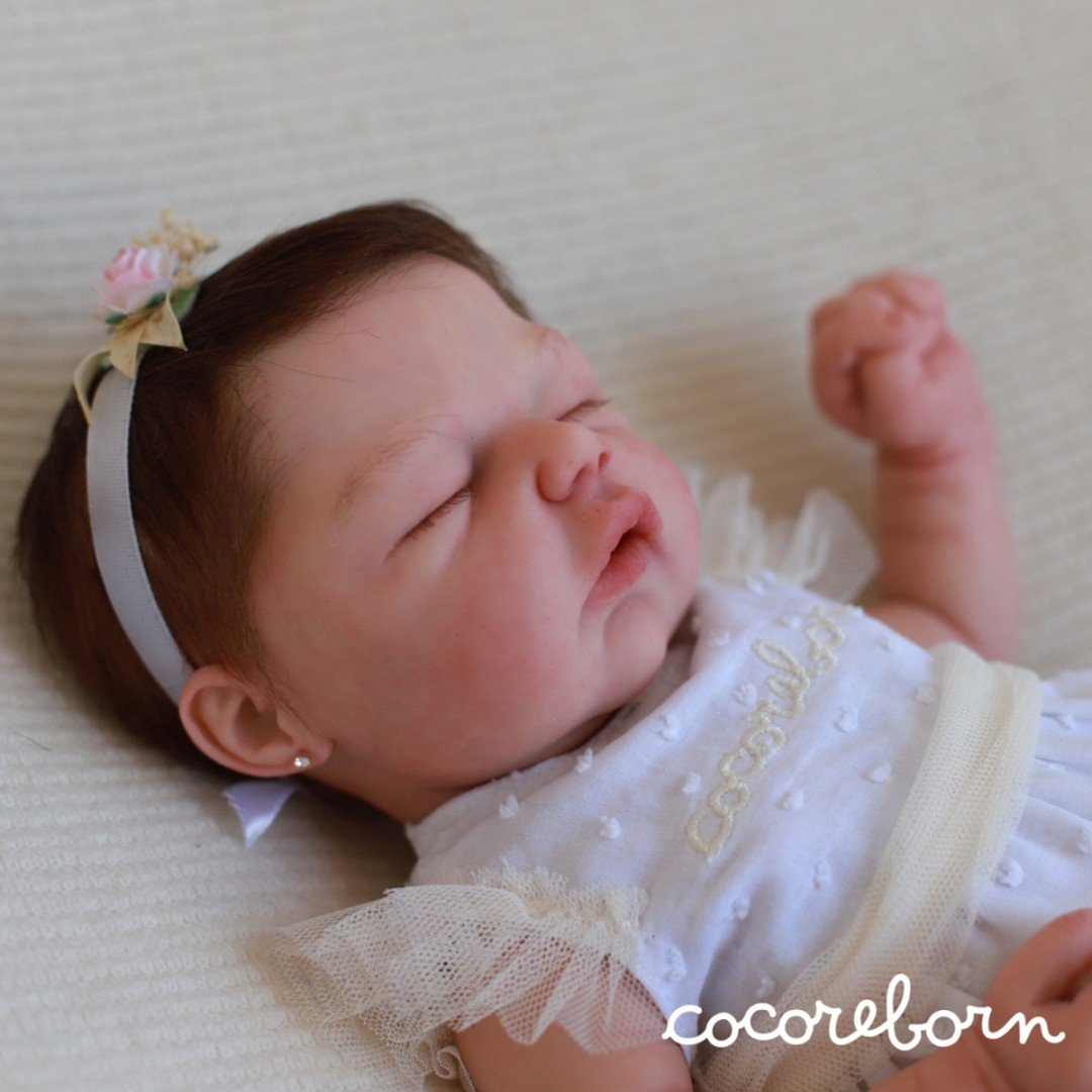 Mimi, a girl with chocolate hair and closed eyes